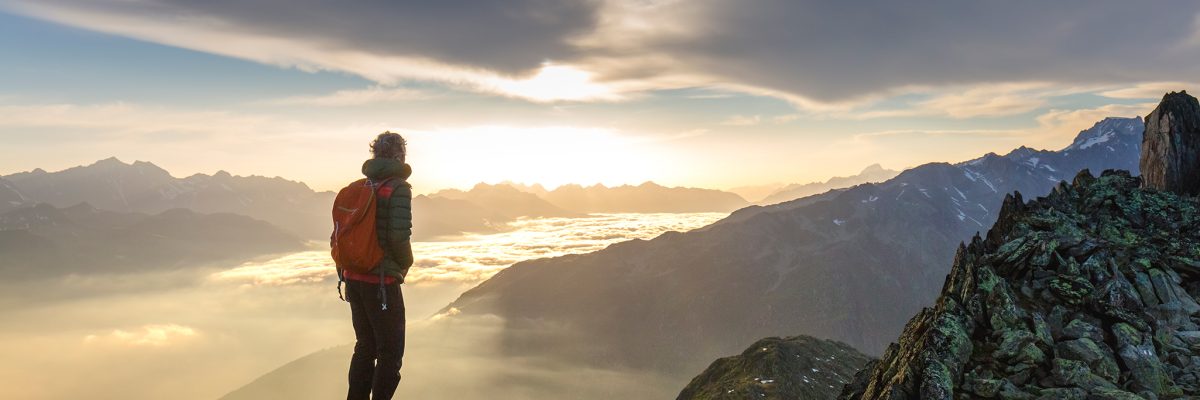man-overlooking-mountain